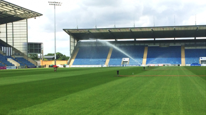 Sprinklers watering the turf at Colchester United Football club